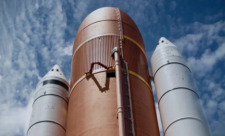 Dramatic view of rocket boosters against a bright blue sky, showcasing aerospace technology